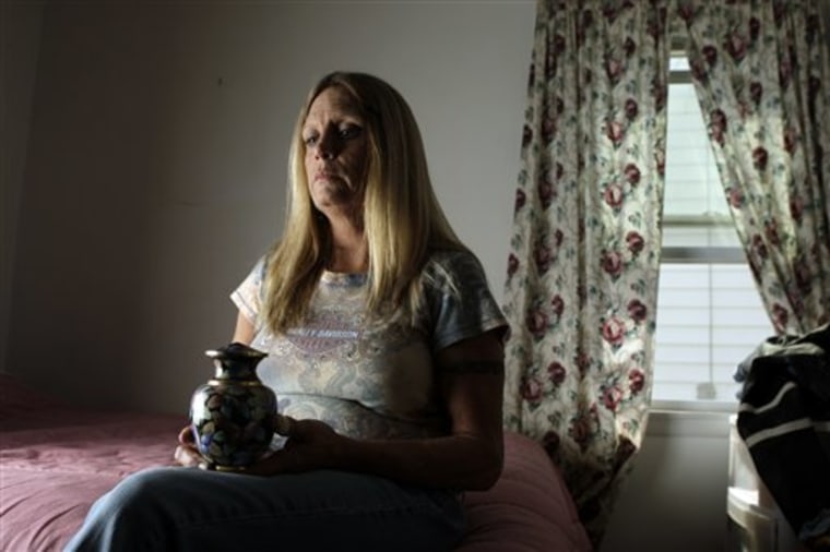 Sue Tayon of Overland, Mo. holds an urn containing the ashes of her daughter Nikki, 28, who died of an overdose of heroin. The mother said the heroin was 90 percent pure.